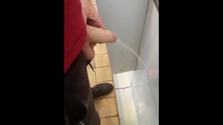 Hung lad at urinal next to me gets semi while pissing!
