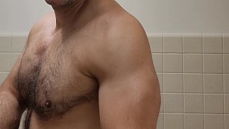 Hairy muscle bear flexing in black tank top