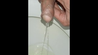 Desperate young man pissing, morning erection, close-up