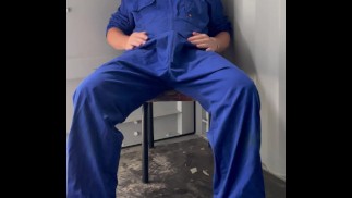 Farm boy in overalls plays at work